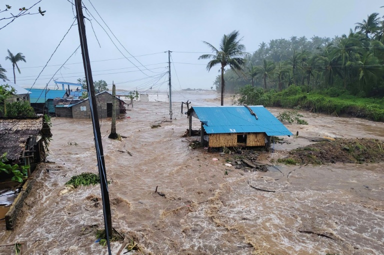 Houses in the Philippines' Catanduanes province swamped by surging floodwater from Typhoon Fung-wong. AFP