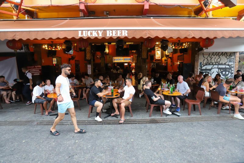People gather with drinks at a pub on Khaosan Road in Bangkok. (Photo: Pattarapong Chatpattarasill)