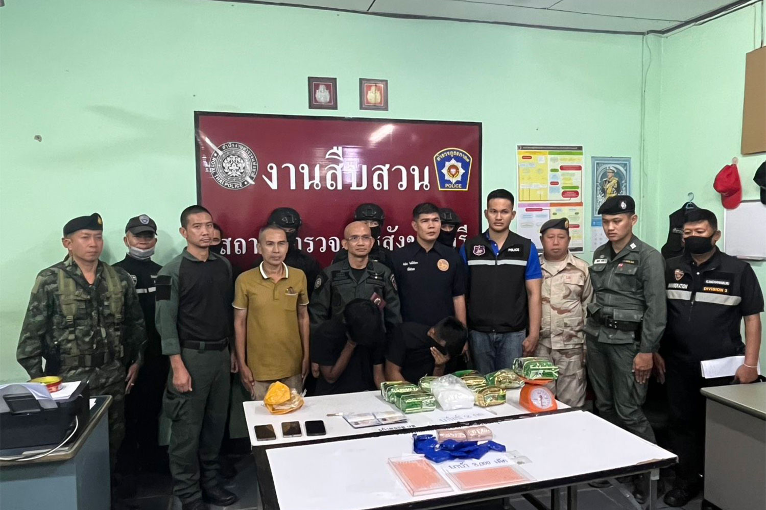 Two Indonesian men arrested on drug charges in Sangkhla Buri district, Kanchanaburi are taken for a media briefing.(Photo: Piyarach Chongcharoen)