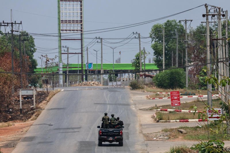 Soldiers from the Karen National Liberation Army patrol on a vehicle, next to an area destroyed by Myanmar's airstrike in Myawaddy on April 15, 2024. &nbsp;Thailand cut power supply to Myanmar across its western border in Mae Sot district in Tak province this year. (Photo: Reuters)