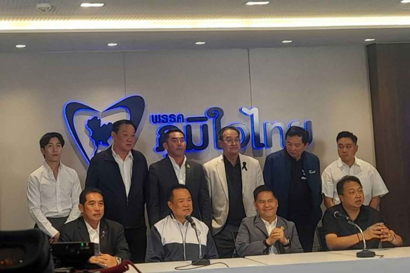Prime Minister Anutin Charnvirakul, seated second from left, joins veteran politicians who defected to the Bhumjaithai Party on Sunday. (Photo: Apinya Wipatayotin)