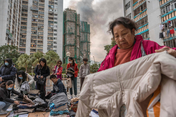 ‘Very worried’: Hong Kong fire survivors hunt for the missing