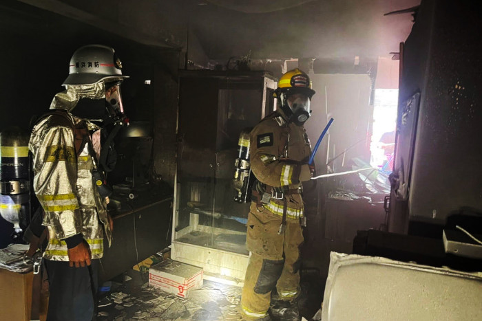 Blaze in mixed-use city building injures 2 Americans