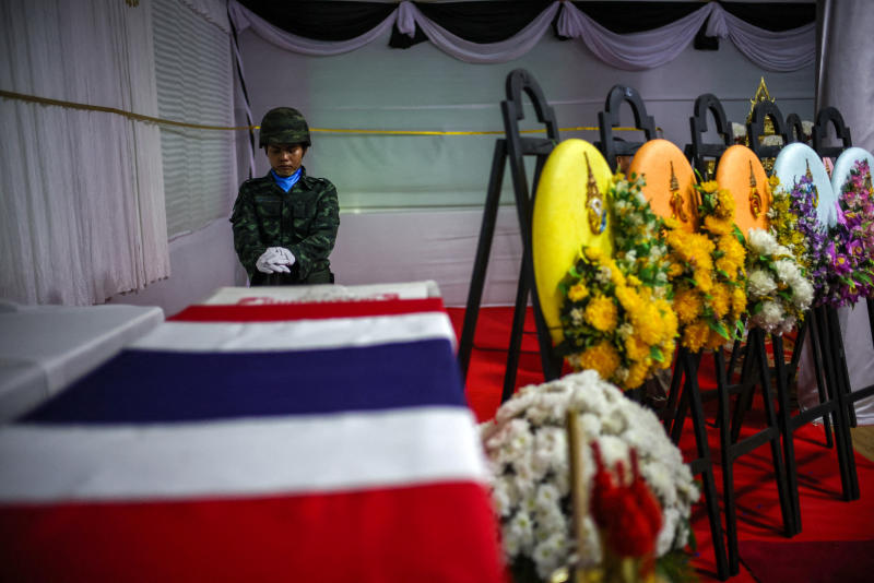 A soldier salutes next to a coffin of Sergeant Major Ananda Udon, 39, a Thai soldier who died on December 10 amid clashes between Thailand and Cambodia along a disputed border area, during his funeral at a temple in Si Sa Ket province, Thailand, on Friday. (Photo: Reuters)
