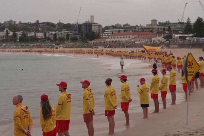 Australian lifesavers line Bondi Beach at vigil after massacre