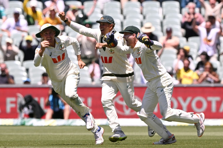 Australia's Marnus Labuschagne (left), Usman Khawaja (centre) and Alex Carey (right) celebrate after Labuschagne caught Josh Tongue to seal the Ashes.