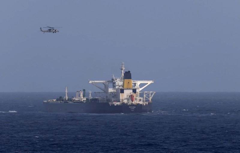 A US military helicopter flies over the Panama-flagged Centuries, which was intercepted by the US Coast Guard, days after President Donald Trump announced a “blockade” of all sanctioned oil tankers entering and leaving Venezuela, in the Caribbean Sea Dec 20, 2025. (Photo: Department of Homeland Security via Reuters)
