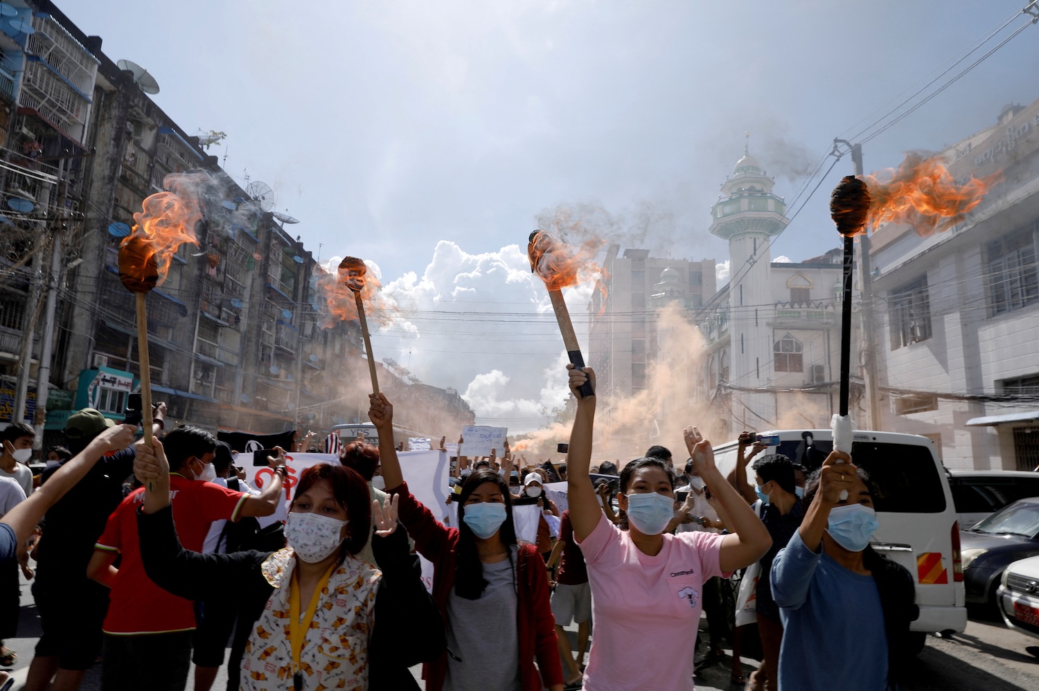 A group of women hold torches as they protest against the military coup in Yangon, on July 14, 2021. (Photo: Stringer via Reuters)