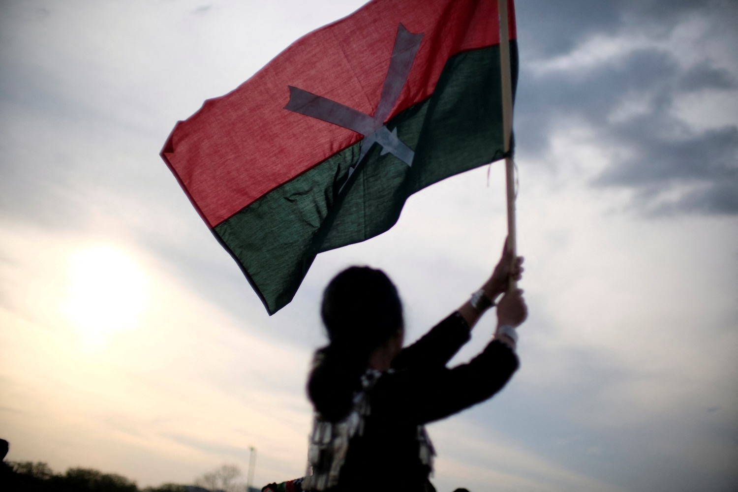 A demonstrator waves a flag during a protest against the military coup in Myanmar at the Washington Monument on the National Mall in Washington DC, on Aptil 10, 2021. (Photo: Reuters) 