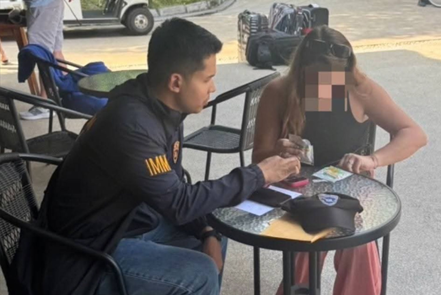 A French woman is arrested at a hotel in Muang district of Phuket. She and her compatriot have been fined 5,000 baht each and their visas revoked over their sex show on a tuk-tuk vehicle in Phuket. (Photo: Achadthaya Chuenniran)