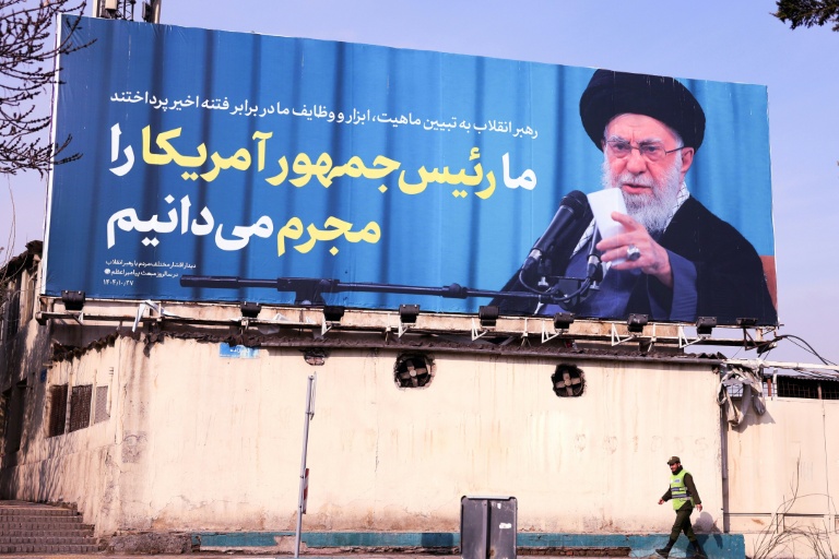 An Iranian soldier walks past a billboard featuring an image of supreme leader Ayatollah Ali Khamenei and an anti-US message, on a street in Tehran on Feb 6, 2026. (Photo: AFP)