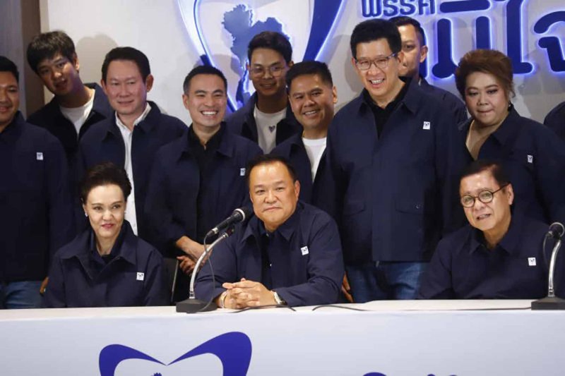 Bhumjaithai Party leader Anutin Charnvirakul, centre, listens to a reporter's question at his party headquarters in Bangkok late Sunday night. (Photo: Nutthawat Wichieanbut)