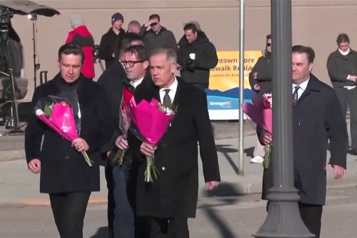 Carney lays flowers at memorial in Tumbler Ridge after mass shooting