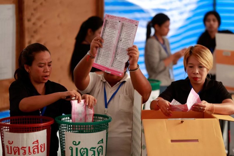 A polling unit staff member holds up a party-list ballot during counting in Bangkok on Feb 8. (Photo: Reuters)