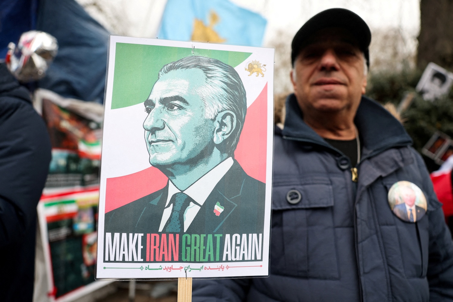 A demonstrator holds a placard depicting Reza Pahlavi, the exiled son of Iran's last shah, as demonstrators gather in support of military action against the Iranian regime, outside the Iranian embassy in London on Feb 28, 2026. (Photo: Reuters)