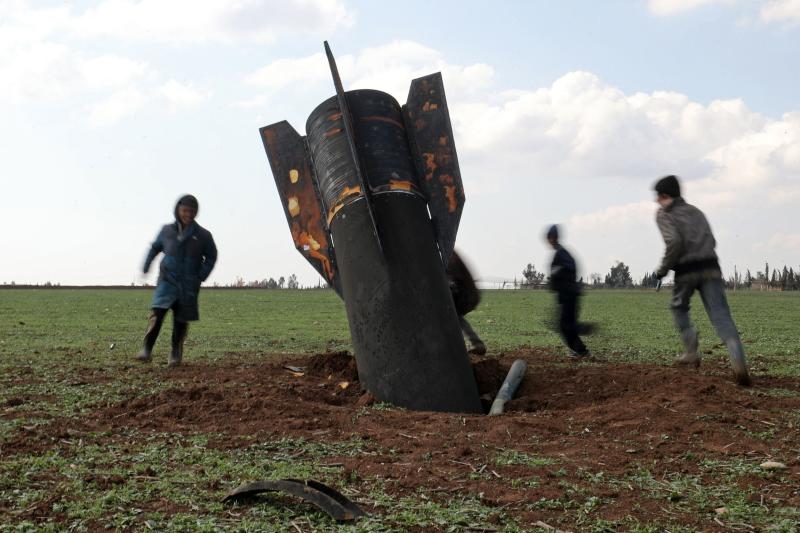 Children play around an unexploded missile that landed in an open field on the outskirts of Qamishli, eastern Syria, on March 5, 2026. (Photo: AFP)