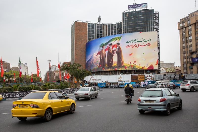 A new billboard at Valiasr square in Tehran shows the late Ruhollah Khomeini, left, looking on as the late Ayatollah Ali Khamenei, center, passes an Iranian flag to to his son, Mojtaba Khamenei, now chosen as Iran's new supreme leader, on Tuesday. (Photo: New York Times)