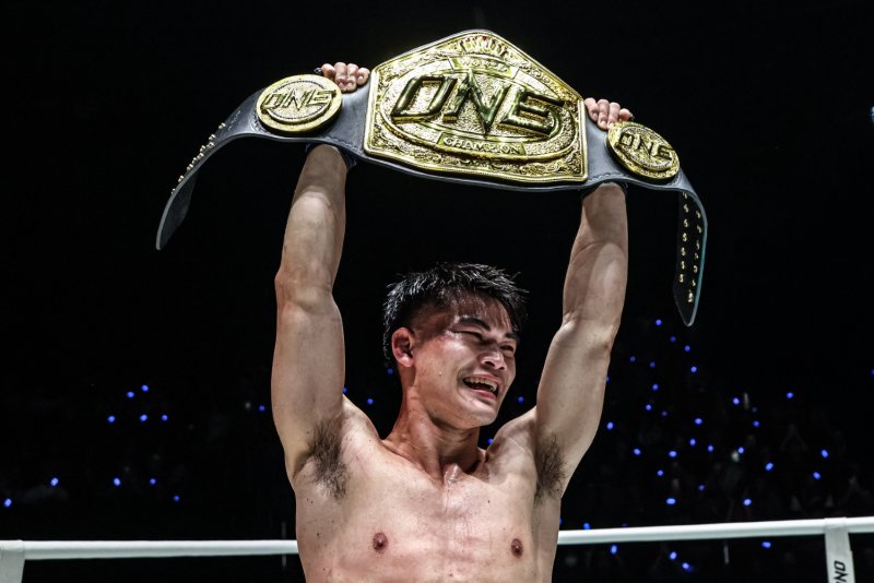 Rambolek raises the ONE Championship bantamweight Muay Thai title in the air