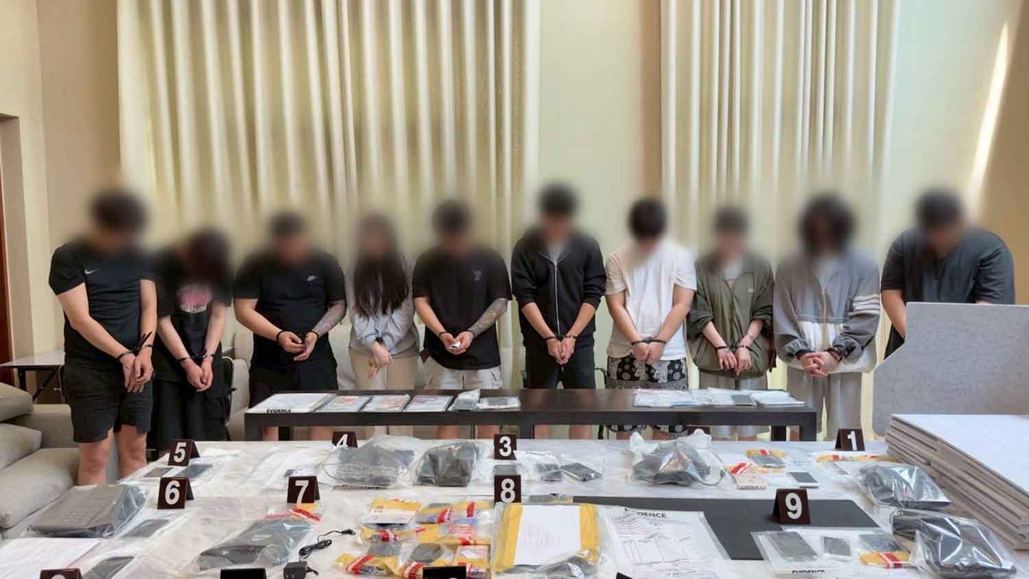 Most of the arrested suspects at the crime scene. (Police photo)