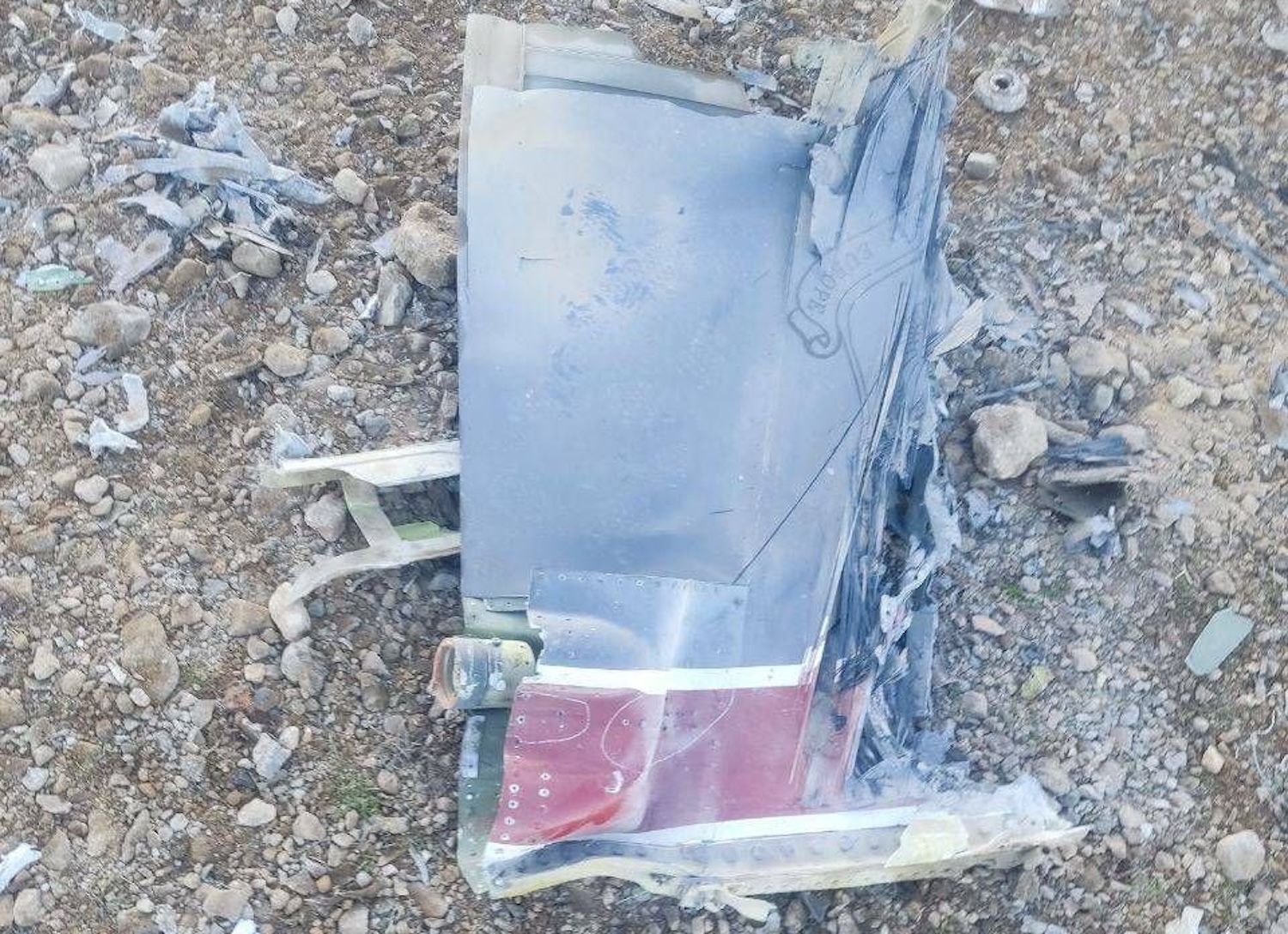 Iranian state media on Friday released an image said to show fragments of a downed US fighter jet. Reuters was not able to confirm the location or date when the photo was taken, but the red stripe seen on the tail fin is consistent with the tail section of an F-15E Strike Eagle. (Photo: IRIB/Handout via Reuters)  