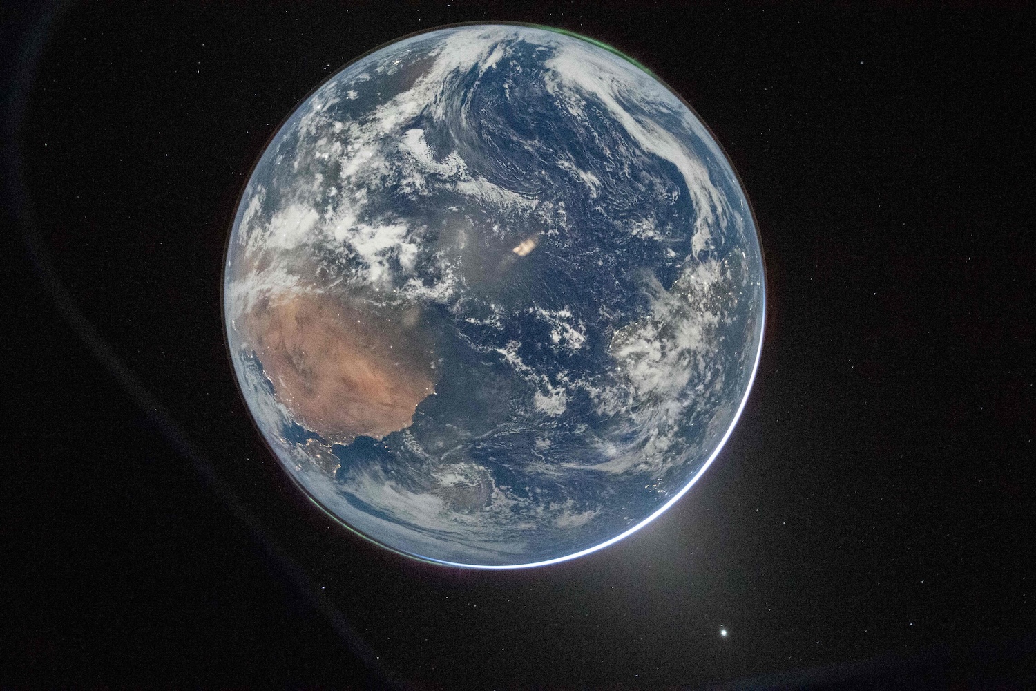 Earth as seen through the Orion spacecraft&rsquo;s window, photographed by NASA astronaut Reid Wiseman, commander of Artemis II, on April 2, 2026. (Photo: NASA via AFP)