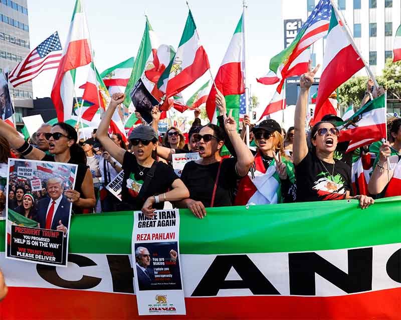 Demonstrators wave flags and march in celebration following US and Israeli strikes in Iran, in Los Angeles, California. (Photo: Reuters)
