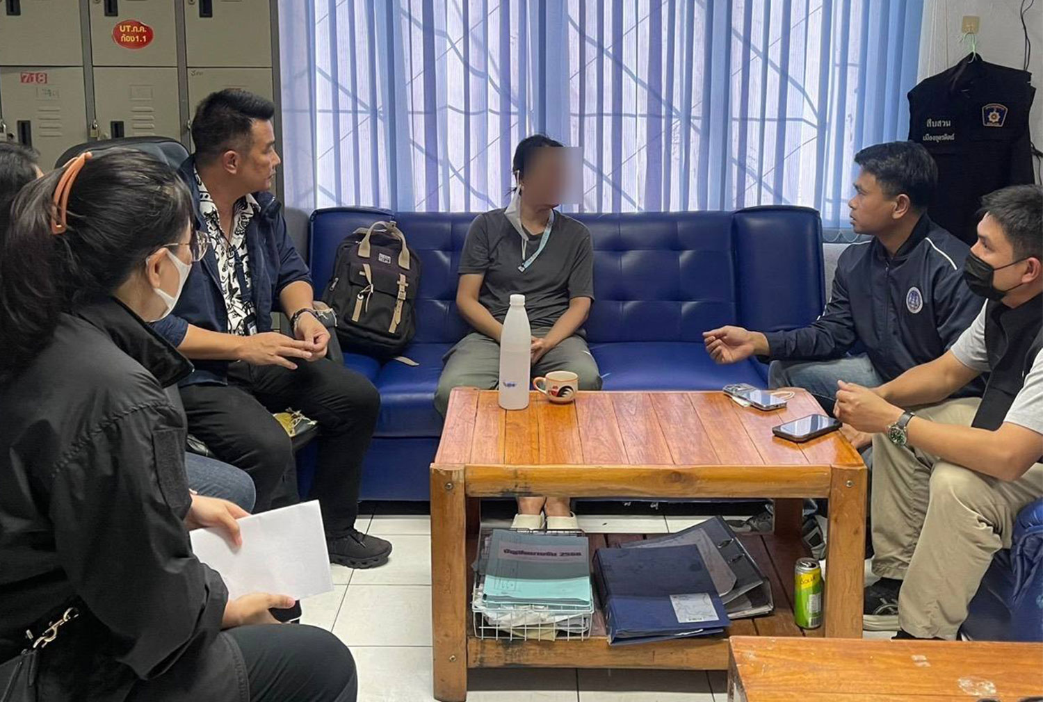 The suspect, centre, is taken to Muang police station in Uttarit for questoning over the alleged 23-million-baht embezzlement case. (Photo:  Public Sector Anti-Corruption Commission)