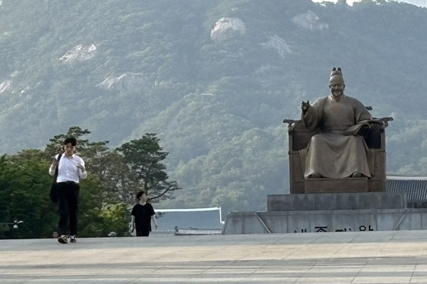 People walks at Gwanghwamun Plaza, one of the landmarks in Seoul. (Photo: Saritdet Marukatat)