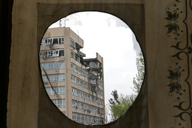 A building damaged by recent strikes is seen from the Golestan Palace in Tehran on April 4, 2026. (Photo: AFP)