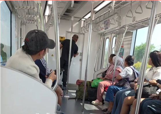 A still from the posted video shows a man passenger knocking the driver's cap to find what happened on the Red Line train Tuesday.