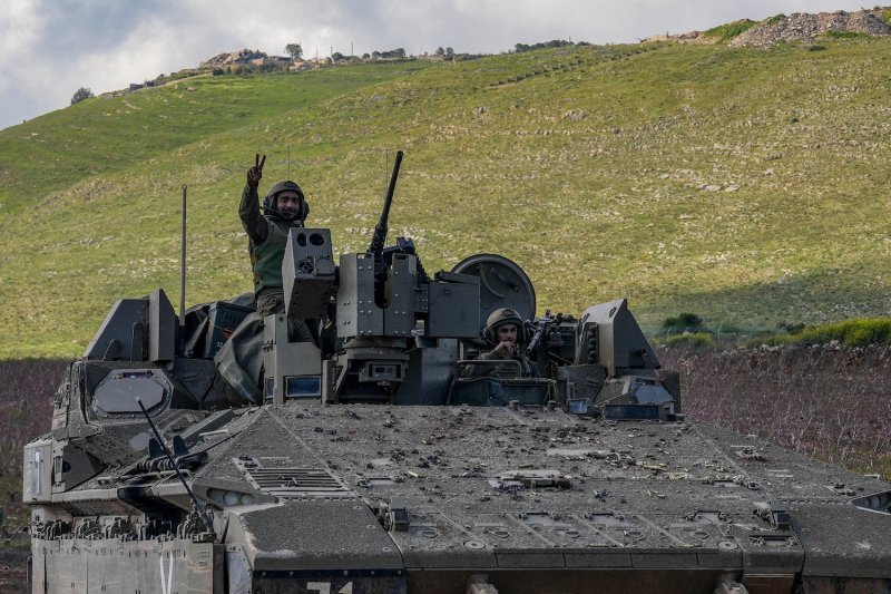 An Israeli soldier gestures from an armoured personnel carrier as it crosses back into Israel from southern Lebanon on April 8, 2026. (Photo: Reuters)