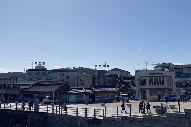 People walk in Suwon, the capital of Gyeonggi province, where a Thai worker is in a hospital after an air gun assault by his employer. (Photo: Saritdet Marukatat)