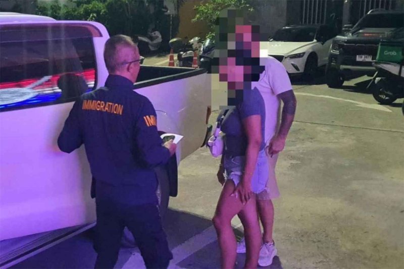 Immigration police brought the foreign couple for interrogation on Monday night. Photo: Phuket immigration police