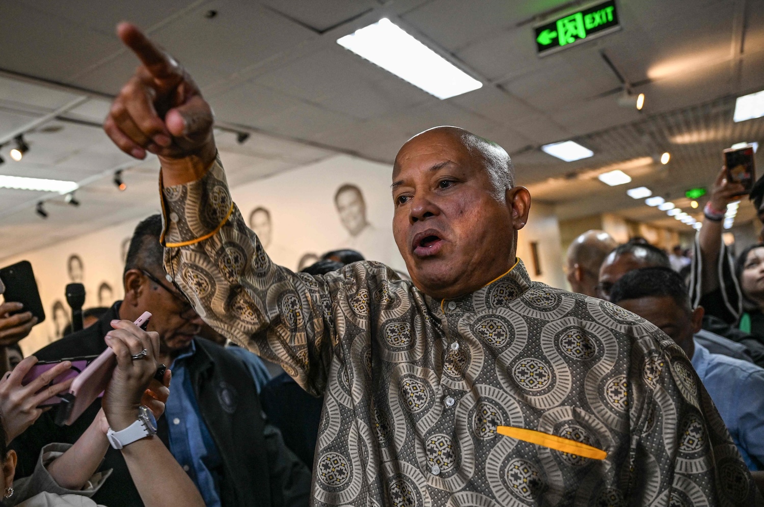 Senator Ronald Dela Rosa, who was chief of police during the early years of former president Rodrigo Duterte’s deadly war on drugs, talks to reporters inside the Senate, where he urged the military to stop government attempts to arrest and fly him to the Netherlands to stand trial for crimes against humanity. (Photo: AFP)