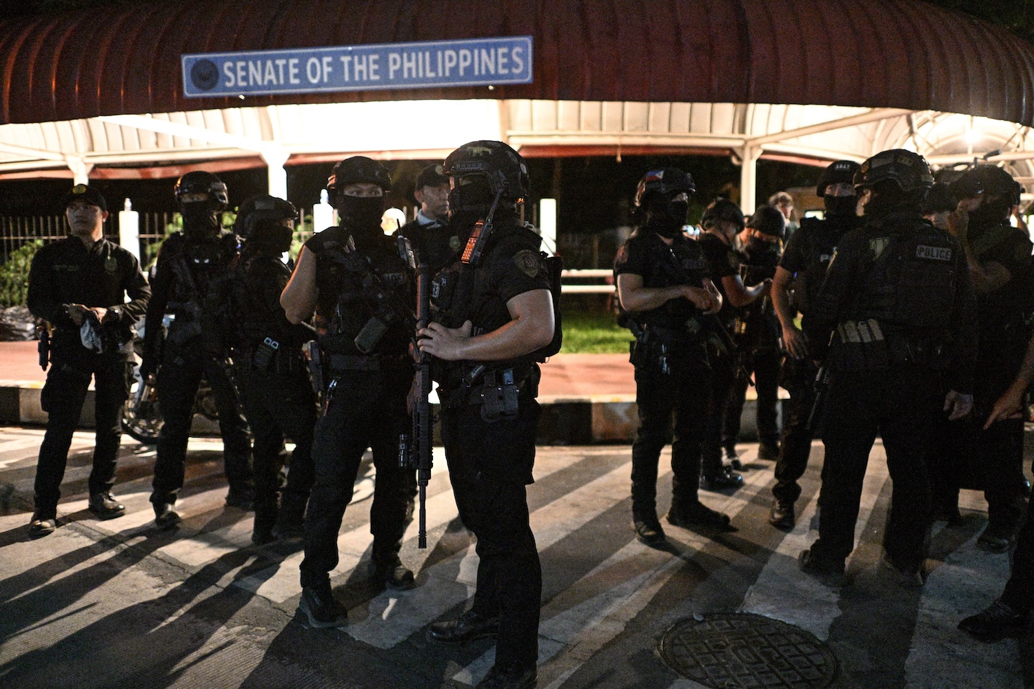 Police SWAT members stand outside the Philippine Senate, where Senator Ronald &ldquo;Bato&rdquo; dela Rosa was said to have been holed up and refusing to submit to arrest, on the night of May 13, 2026. (Photo: Reuters)