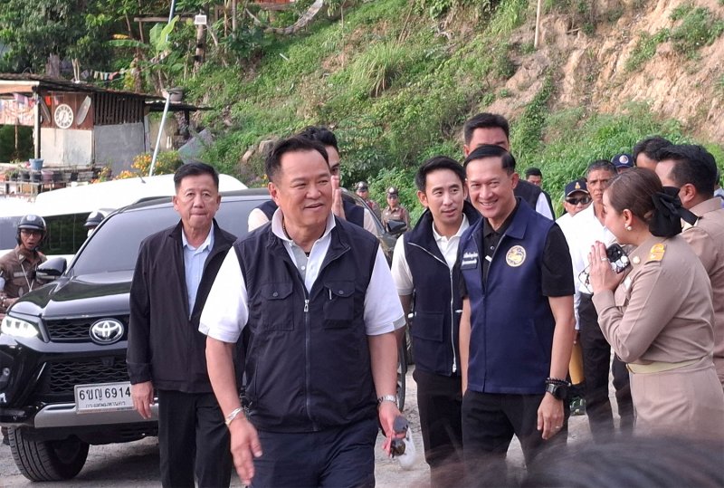 Prime Minister Anutin Charnvirakul, front centre, is greeted by local officials as he leads a delegation to inspect alleged foreign nominee businesses, illegal land encroachment and other unlawful activities in Phuket province on Wednesday. (Photo: Achadthaya Chuenniran)