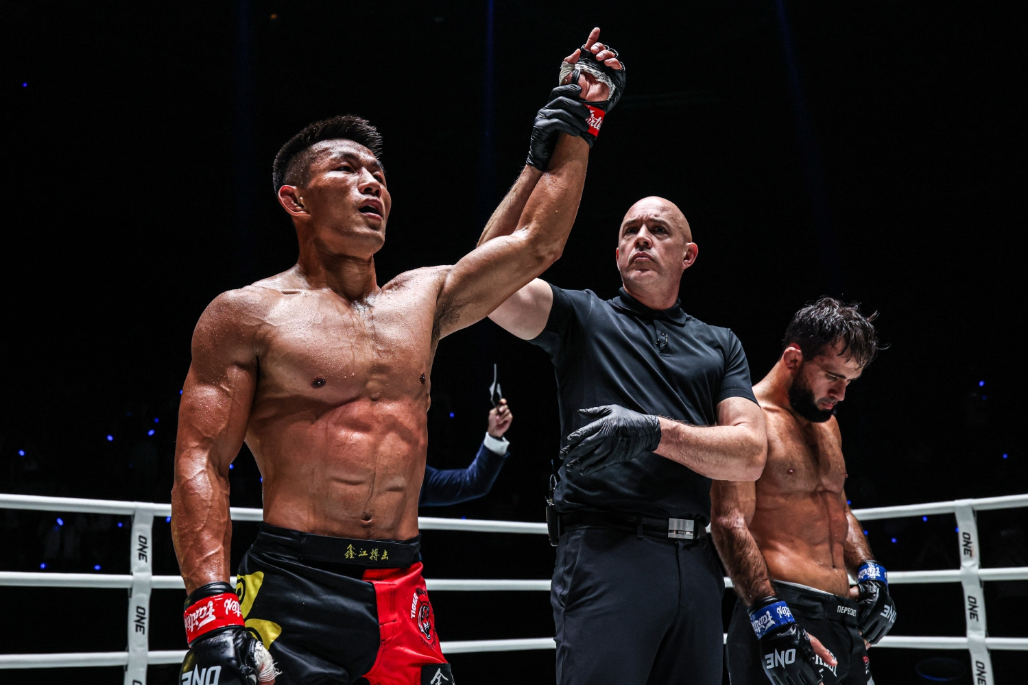 Tang Kai_s arm is raised by referee Olivier Coste at ONE Fight Night 43