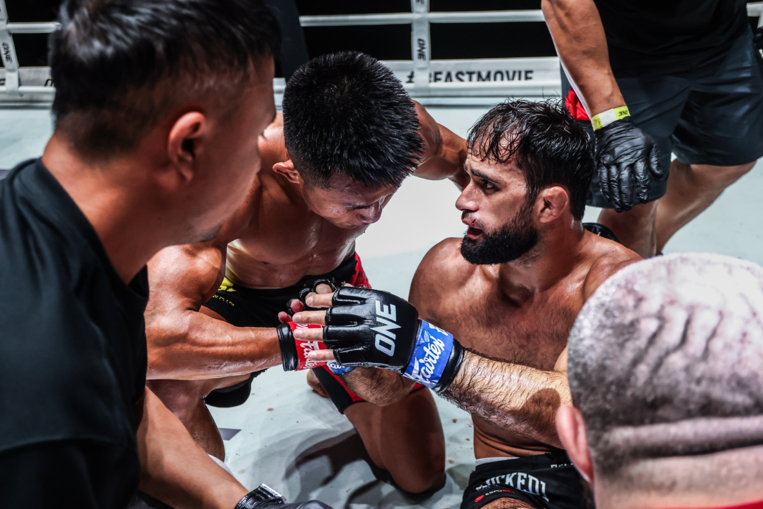 Tang Kai consoles Shamil Gasanov after his victory at Lumpinee Stadium in Bangkok