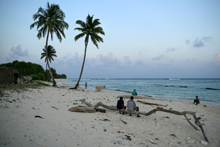 Local residents sit on Old Shastri Nagaram Beach on the outskirts of Campbell Bay on Great Nicobar Island. afp