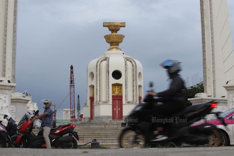 Motorcyclists ride past Democracy Monument on Ratchadamnoen Klang Avenue in Bangkok. (Pattarapong Chatpattarasill)