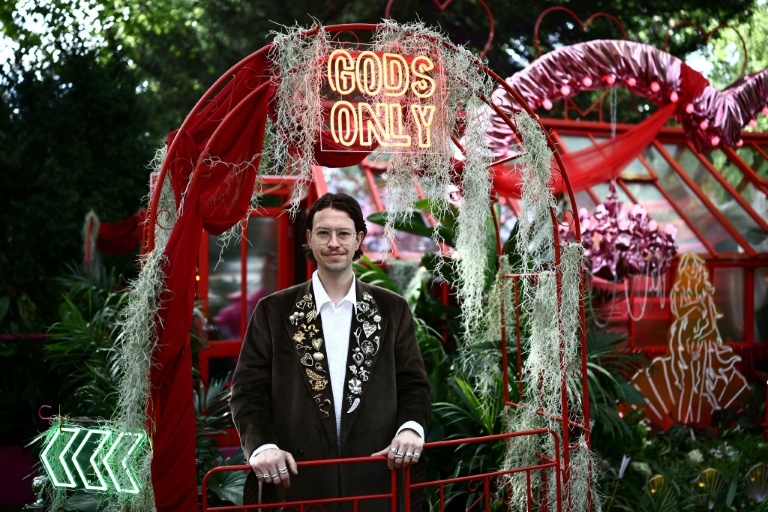 Designer James Whiting poses at his exhibit 'Aphrodite's Hothouse' billed as 'lush, fragrant and just a little bit naughty' at the 2026 RHS Chelsea Flower Show in London. (Photo: AFP)