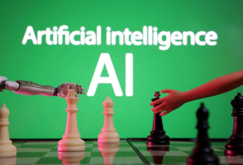 Words reading "Artificial intelligence AI", miniature of robot and toy hand are picture in this illustration taken on Dec 14, 2023. (File photo: Reuters)