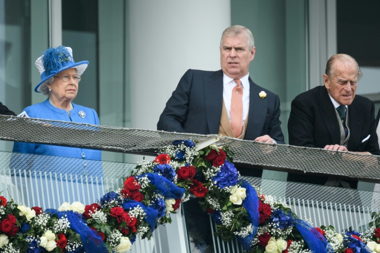 The late UK Queen Elizabeth II, left, and the former Prince Andrew, centre, with his father Prince Philip are pictured at the Epson races in 2016. (Photo: AFP)