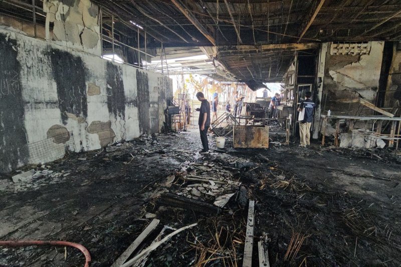 Pattaya City officials check for damage on the eighth floor of Sunday JA Plus Hotel on Friday in the wake of a fire. (Photo: Amporn Sangkaew)
