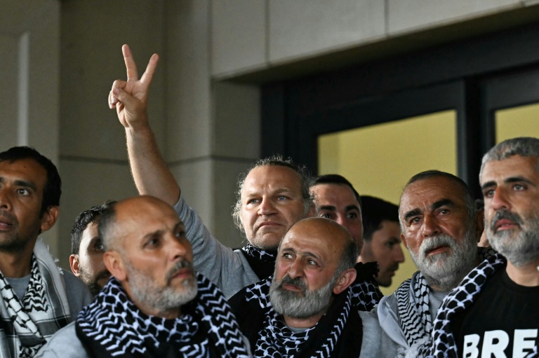 Members of a Gaza-bound flotilla pose outside a terminal following their arrival at Istanbul airport. (Photo: AFP)