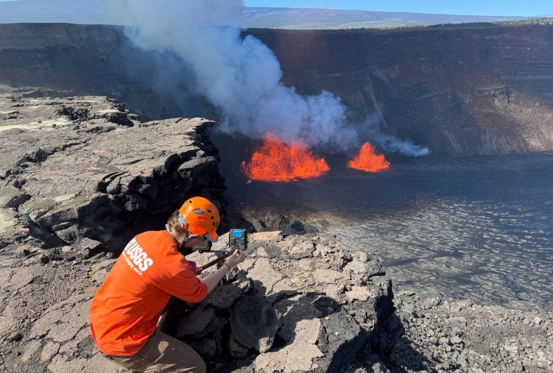 A geologist checks a webcam located on the rim of the caldera during an eruption at the Kilauea volcano in Hawaii, on Dec 23, 2024. (Photo: USGS/M Patrick via Reuters) 