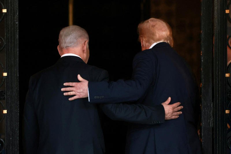 Israeli Prime Minister Benjamin Netanyahu, left, and US President Donald Trump embrace as they walk into Trump's Mar-a-Lago club in Palm Beach, Florida, the United States, on Dec 29, 2025. (Photo: Reuters)