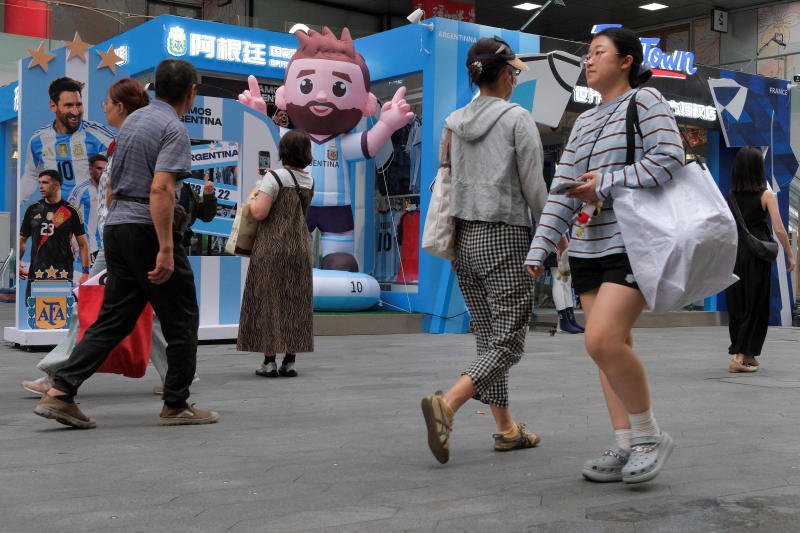 People walk past a World Cup-themed pop-up store in Shanghai on Friday. (Photo: Reuters)