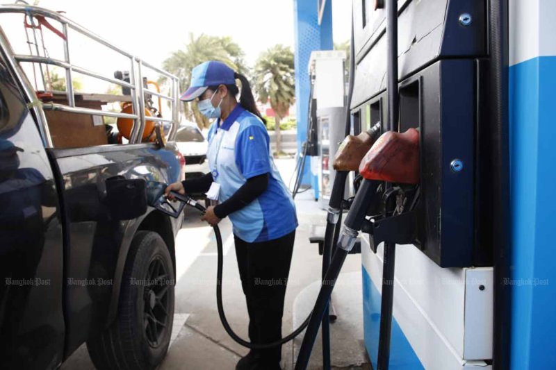 A pump attendant fills a pickup truck's tank in Thailand. (Bangkok Post file photo)