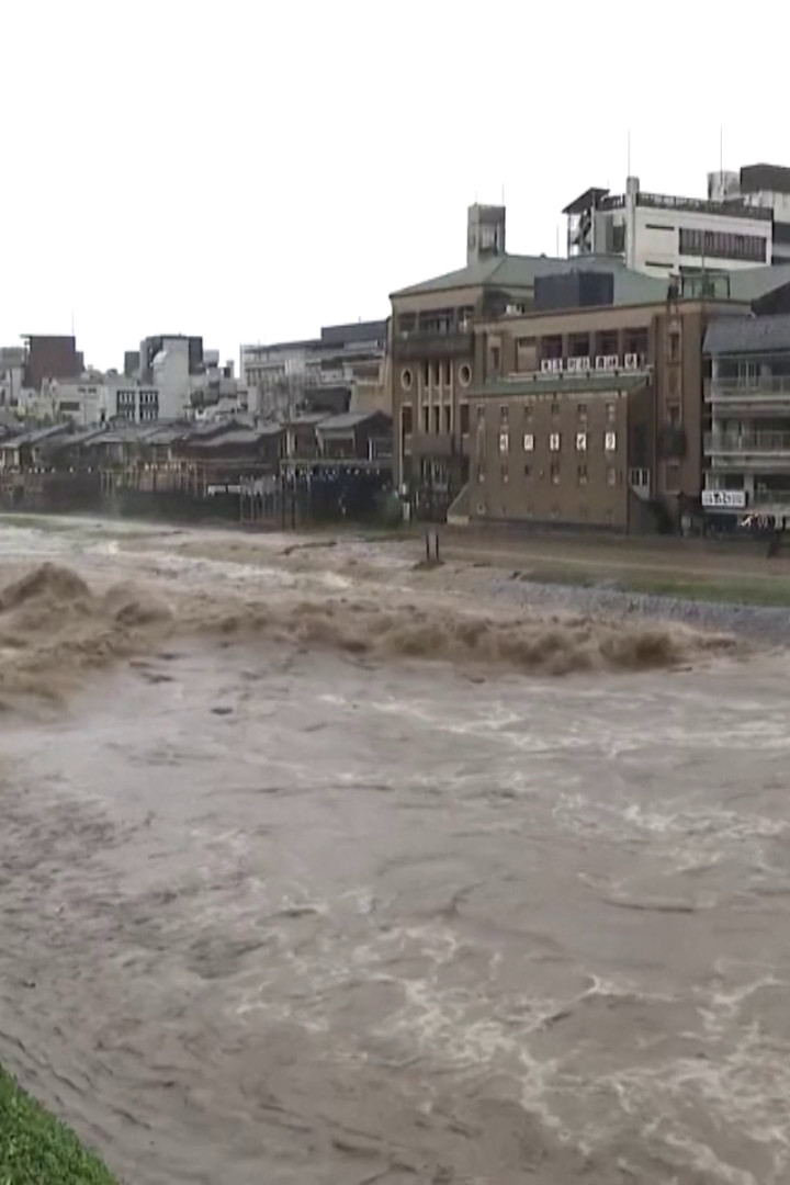 Kyoto's Kamo River surges with muddy torrent after heavy rainfall